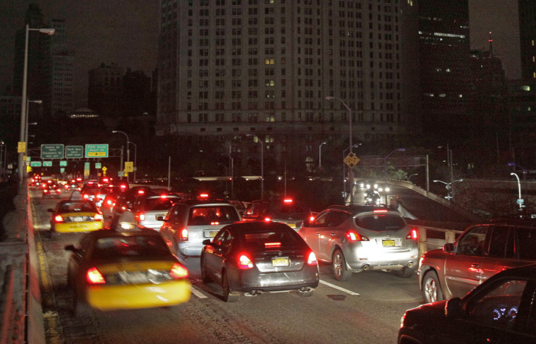 Early morning commuters cross New York's Brooklyn Bridge on Oct. 31, the first morning it's been open to vehicle traffic since Hurricane Sandy.