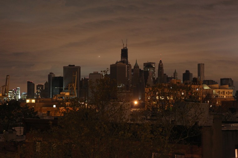 The dark skyline of lower Manhattan is seen from a rooftop in Brooklyn on Oct. 30.