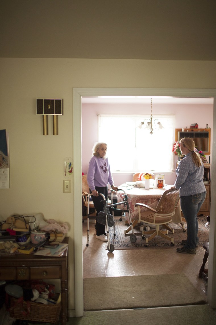 Amy Cooper, a caregiver with Senior Helpers in New Jersey, helps Alzheimer's patient Helen Gatanis at home. Cooper delayed her own family's evacuation as storm Sandy approached as she tried to make sure Gatanis was safe.