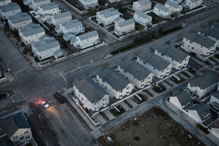 At dawn, a police car patrols an empty waterfront neighborhood that lost power as a result of Hurricane Sandy in Atlantic City, N.J., on Oct. 31.