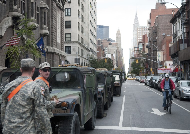 Army National Guard troops from upstate New York stand in front of the the 69th Regiment Armory in Manhattan, on Wednesday.