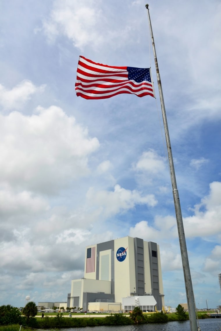 The U.S. flag flies at half mast outside the Vehicle Assembly Building in honor of Neil Armstrong at the Kennedy Space Center, Friday in Cape Canaveral, Florida.