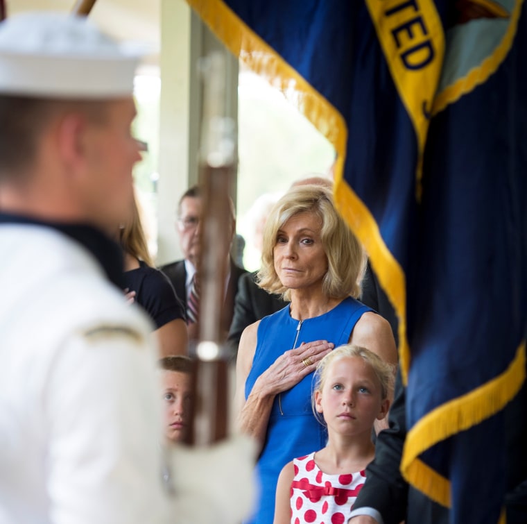 Carol Armstrong, wife of Neil Armstrong, and Piper Van Wagenen, one of the late astronaut's 10 grandchildren, watch an honor guard pass by during a memorial service on Friday at the Camargo Club in Cincinnati.