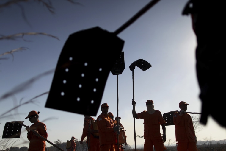 Firefighters gather during efforts to extinguish a fire in rural Brazil, Sept. 3.