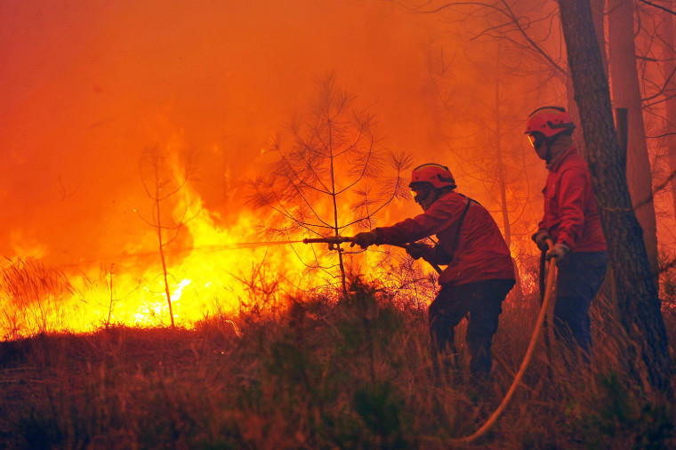 Firefighters combat a forest fire in Quinta da Sobreira, central Portugal, on Sept. 4.