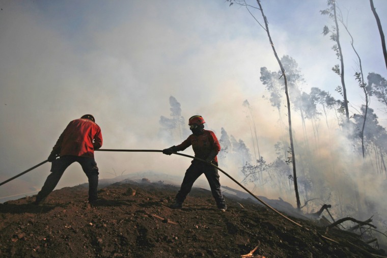 Firefighters combat a forest fire in Alvaiazere, near Ourem, Portugal, Sept. 4.