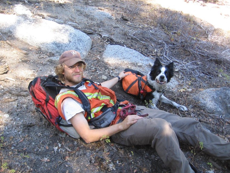 Bud Marks and rescue dog Frehley take a break from sniffing out ailing salamanders. Like other Conservation Canines, Frehley received his training at the University of Washington's Center for Conservation Biology.