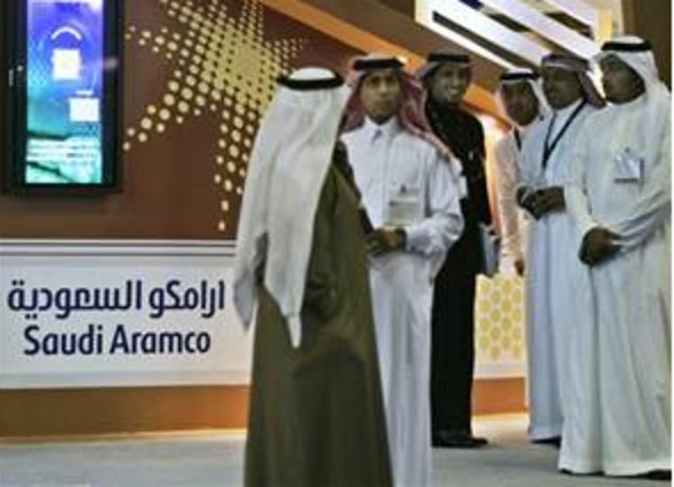 n this Tuesday, Dec. 4, 2007 file photo, Employees of the Saudi Aramco oil company prepare for the first day of the Arab Oil and Gas exhibition in Dubai, United Arab Emirates.