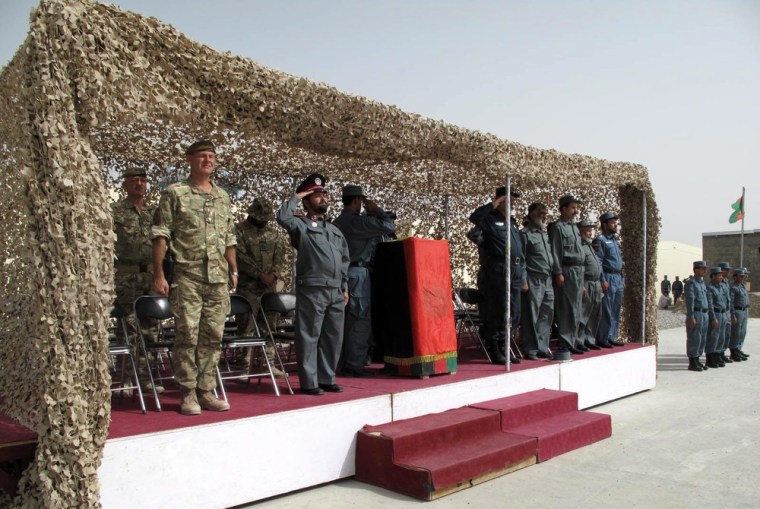 Afghan police attend their graduation ceremony in volatile Helmand, Afghanistan, on Wednesday. International troops in the country have suspended their training program for Afghan security forces following a spate of attacks on foreign soldiers by Afghans in uniform.