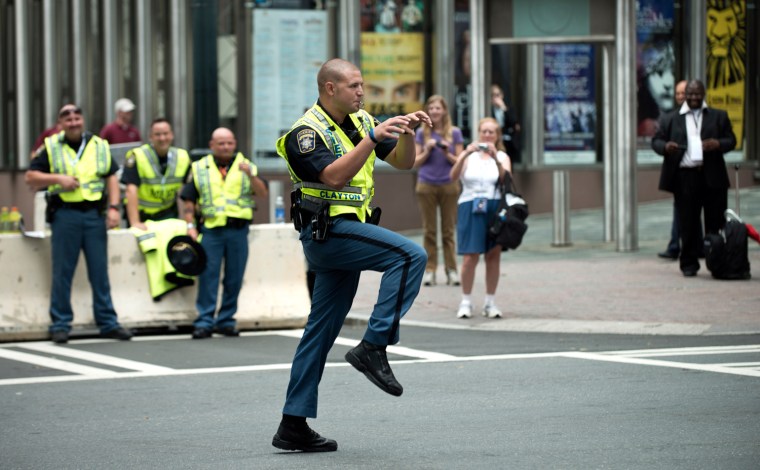 A sheriff's deputy puts a bit of creativity into directing traffic as people arrive for the second day of the 2012 Democratic National Convention at the Time Warner Arena September 4, 2012 in Charlotte, North Carolina.