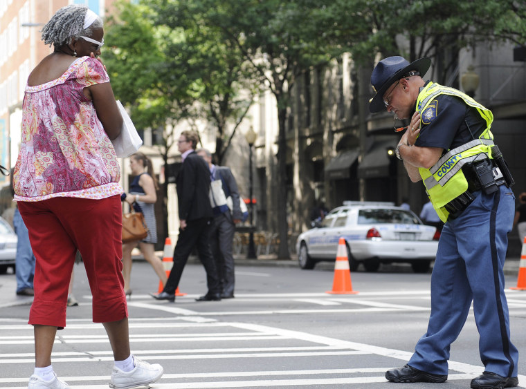 Clayton County (Ga.) Sheriff Capt. Samuel Smith reacts to a spectators comments about his dancing while directing traffic, Wednesday, Sept. 5, 2012, in Charlotte, N.C.