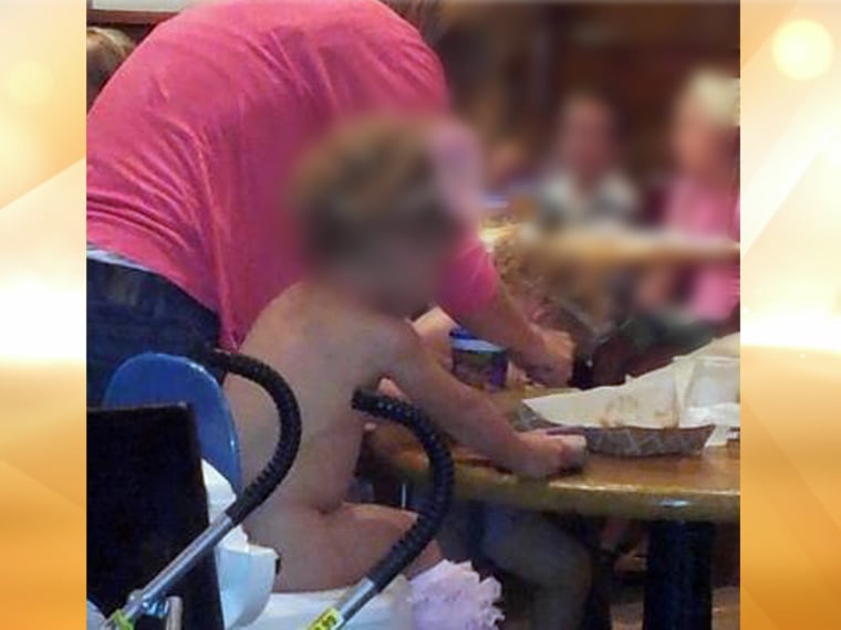 Multi-tasking: A child potty trains while having lunch in a restaurant.