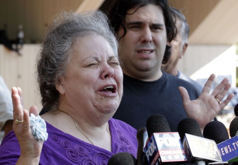 Marcia Savio, step-mother of Kathleen Savio cries outside the Will County Courthouse after word that Drew Peterson was found guilty of murdering his third wife Kathleen Savio. She is accompanied by Kathleen Savio's half-brother Nicholas Savio.