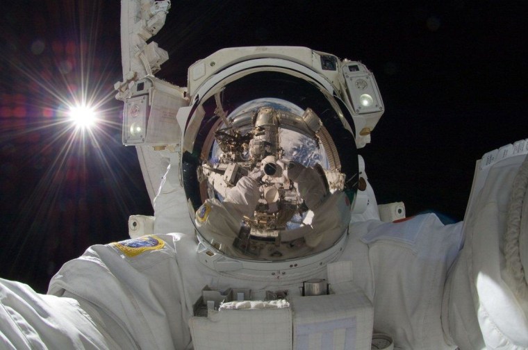 Japanese astronaut Aki Hoshide's self-portrait, taken during a Sept. 5 spacewalk, shows the International Space Station and Earth mirrored in his helmet visor.