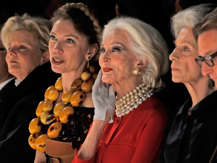 Carmen Dell'Orefice, wearing bold red, watches the Chado Ralph Rucci Spring 2013 on Sept 9.