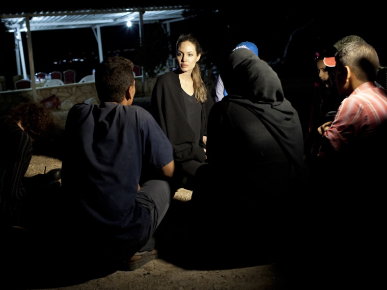 UNHCR Special Envoy Angelina Jolie meets with refugees on the Jordanian border minutes after they crossed from Syria on Sept. 10.