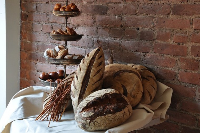 The selection of breads and pastries at Brooklyn's Bien Cuit bakery include chewy rolls and long-fermented miches (a dark-crusted French country bread).