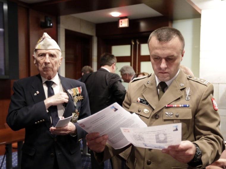 Col. Andrzej Kopacki, right, an assistant military attache with the Polish Embassy in Washington, attends an event on Capitol Hill to announce the release of information about the 1943 Katyn Forest massacre. At left is W.J. Milan-Kamski of Easton, Md., who is a native of Poland and World War II veteran with the Polish Army, 2nd Armored Division.