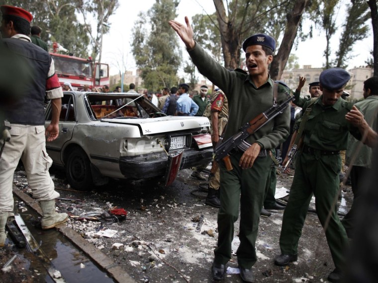 A police trooper shouts at the scene of a car bomb blast in Sanaa, Yemen, on Sept. 11, 2012. A bomb targeting Yemeni Defense Minister Maj. Gen. Muhammad Nasir Ahmad exploded outside the prime minister's office in Sanaa but the minister was safe, government sources said.