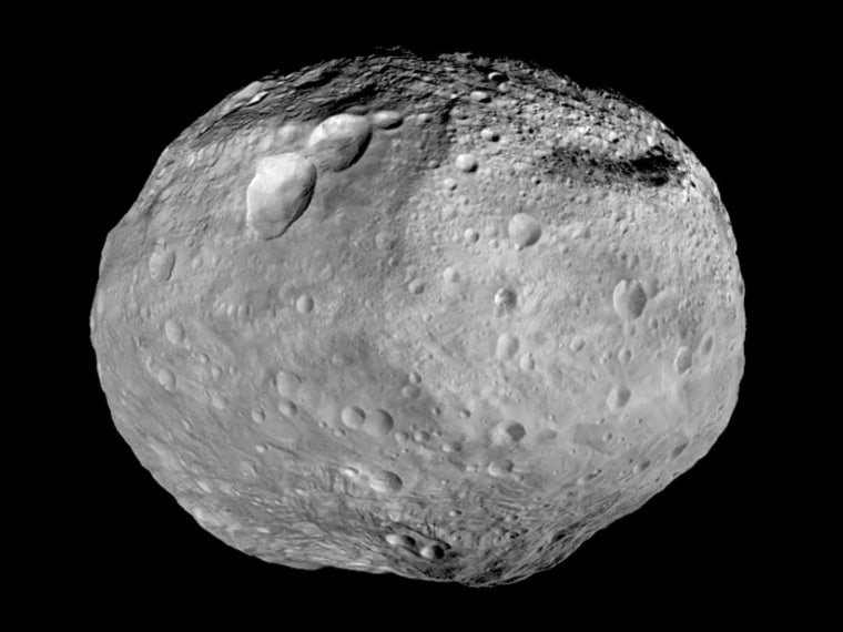 This image mosaic synthesizes some of the best views that NASA's Dawn spacecraft obtained during more than a year in orbit around the asteroid Vesta. A towering mountain, rising more than twice the height of Mount Everest, sticks out from the south pole at the bottom of the image. A chain of three craters known as the