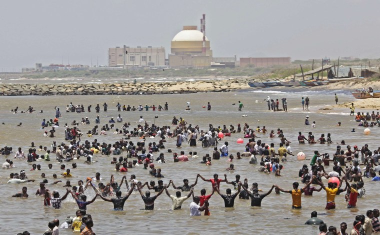 Demonstrators stand in the waters of the Bay of Bengal near the plant.