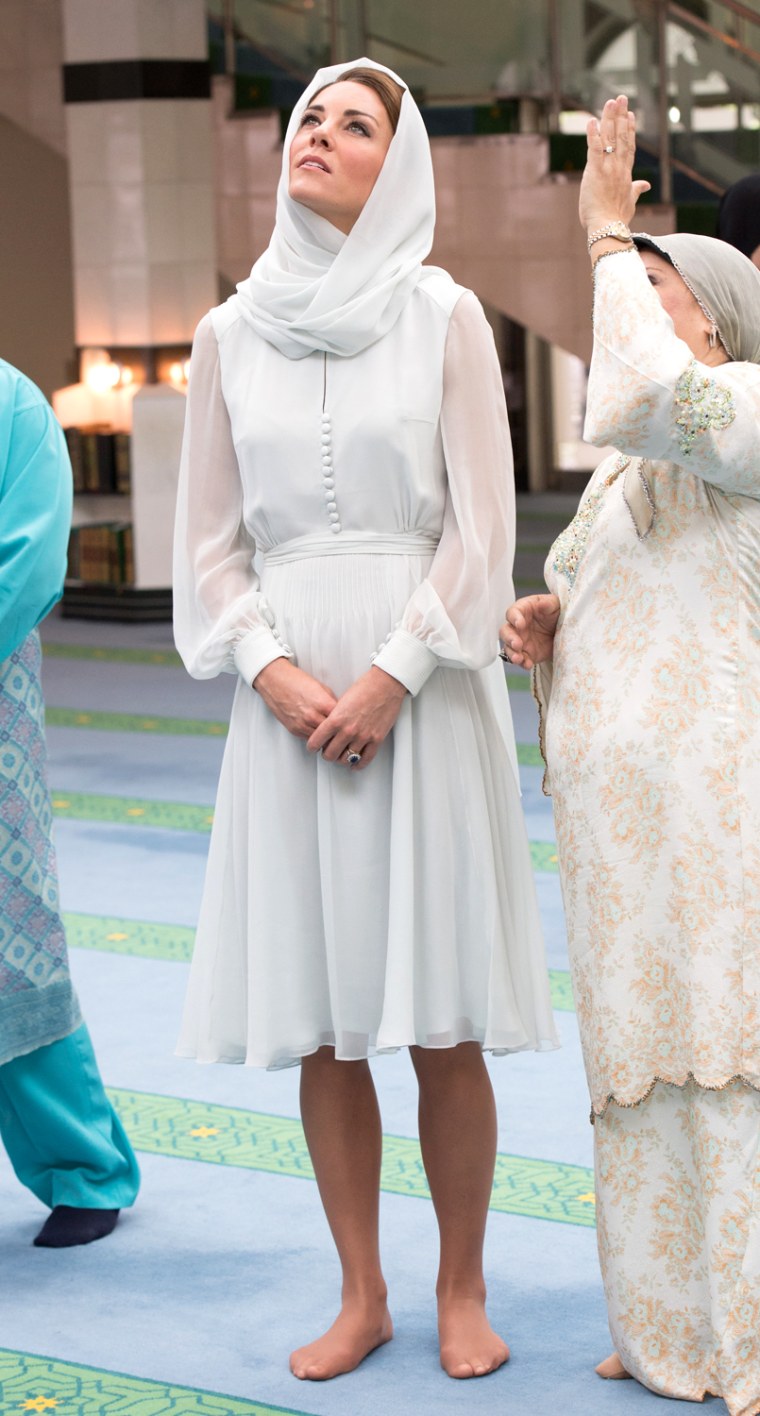 A vision in white: Kate covers up while visiting Assyakirin Mosque in Kuala Lumpur, Malaysia.