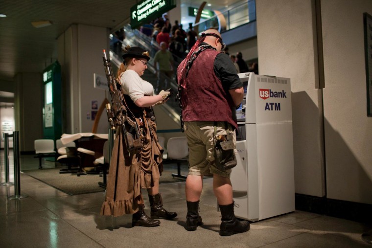 Tryston Adachi, right, and Jackie Cunard withdraw money while sporting