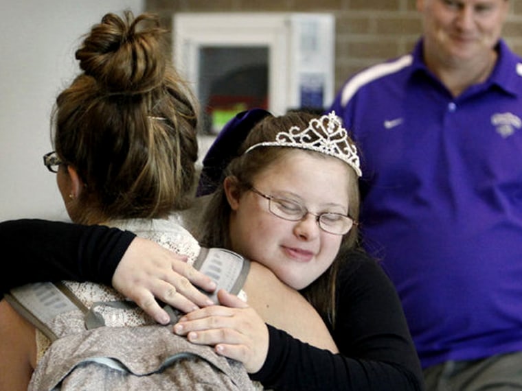 'I feel awesome.' Allyssa Brubeck, who has Down syndrome, got a hug from varsity cheeleader Emma Woodson after being elected Homecoming Queen.