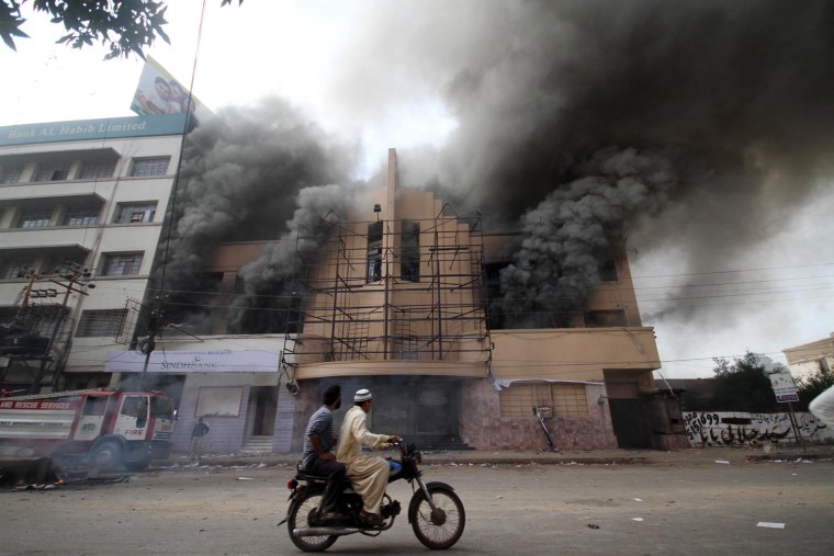 Smoke rises from a building which was set on fire by a mob during a protest against the anti-Islam movie entitled 'Innocence of Muslims' made in the US, in Karachi, Pakistan, on Sept. 21.