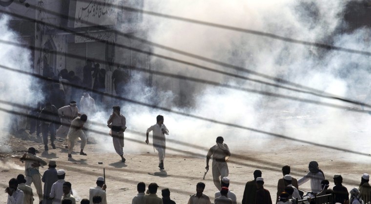 A general view shows policemen facing protesters during a protest against the anti-Islam movie entitled 'Innocence of Muslims' made in the US, in Peshawar, Pakistan, on Sept. 21.
