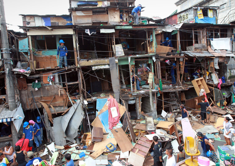 Armed with rocks and bottles, squatters clash with police as homes are ...