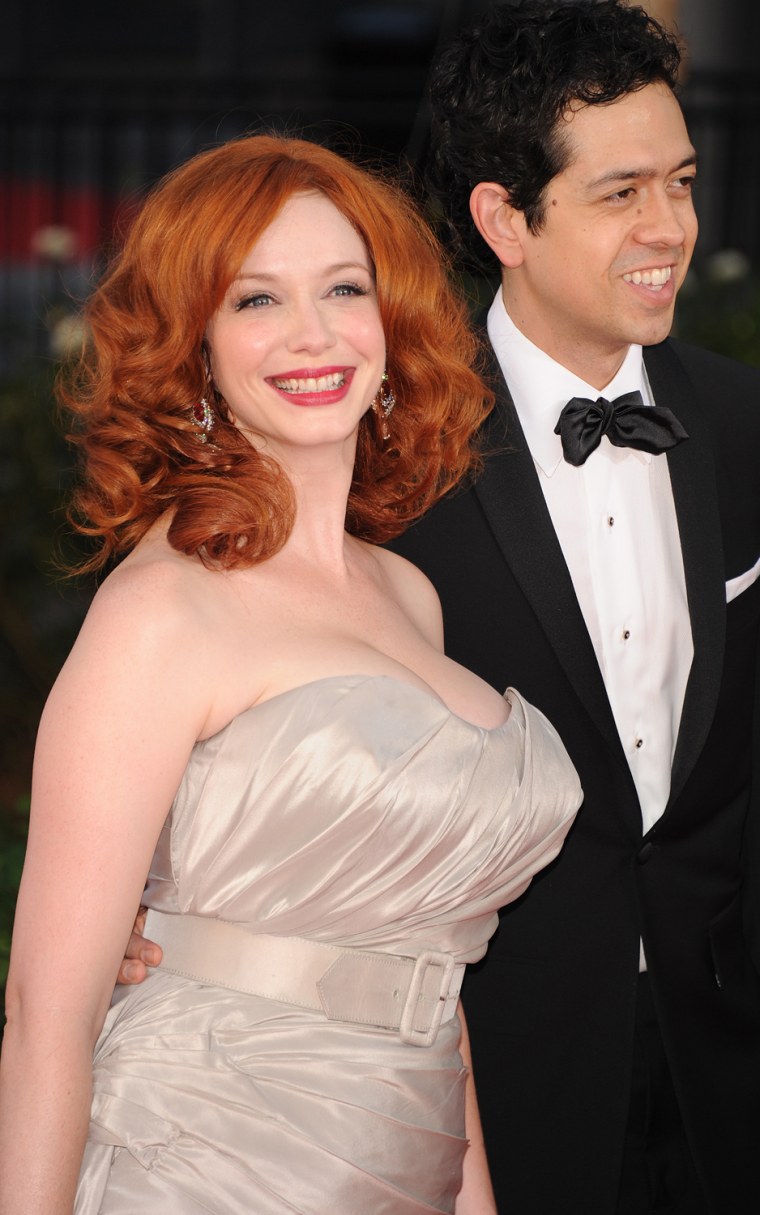 Christina Hendricks and her husband, Geoffrey Arend, arrive for the Emmy Awards.