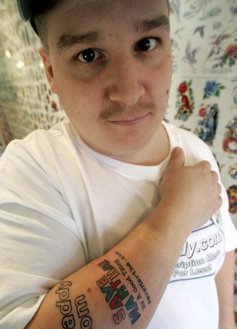 Joe Tamargo shows off a tattoo.