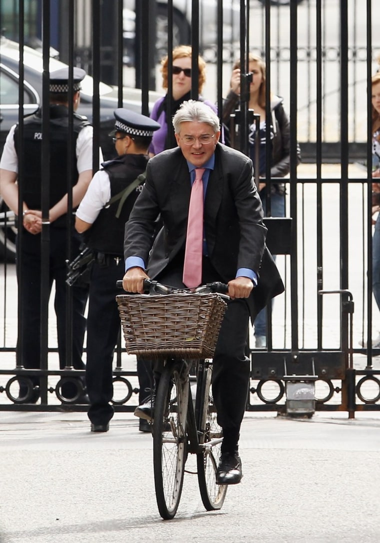 British minister Andrew Mitchell, who reportedly insulted police officers after they stopped him from cycling out of the main gate down the street from the prime minister's official residence, arrives at a government meeting in May.