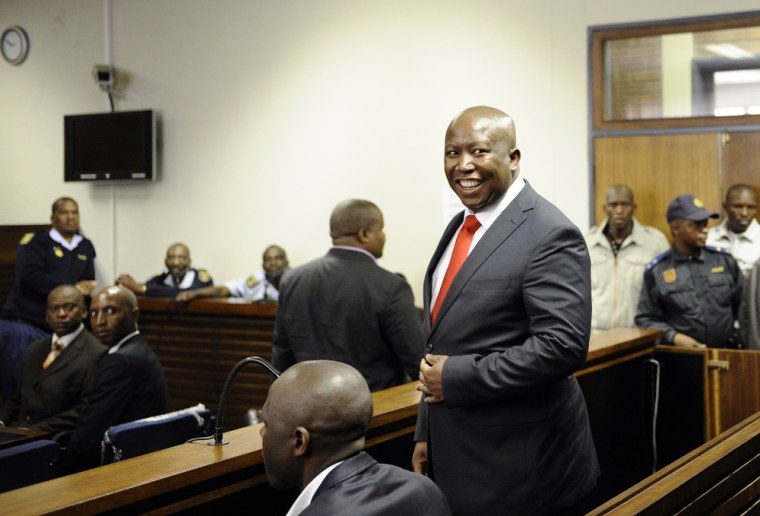 South African populist firebrand Julius Malema, a former leader of the African National Congress' Youth League, smiles as he arrives in court on Wednesday.