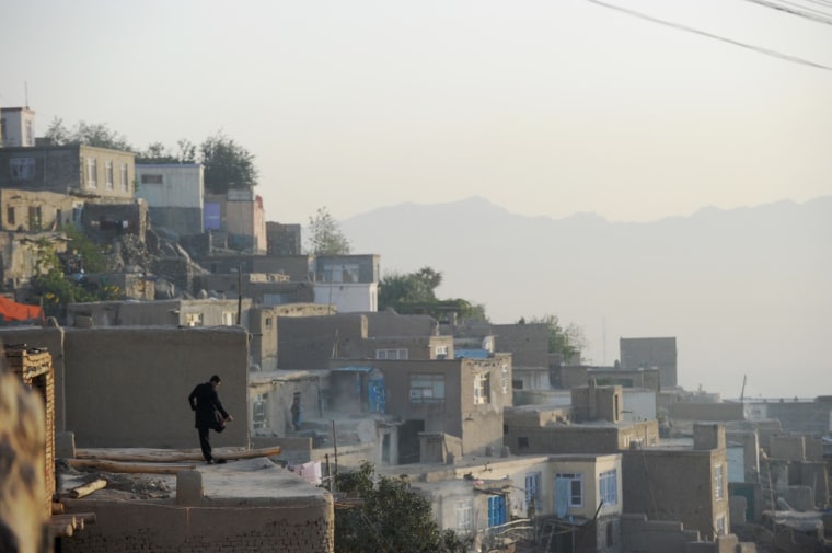 A resident of the hillside neighborhood of Jamal Mina stands in front of his home high over Kabul on Sept. 27.