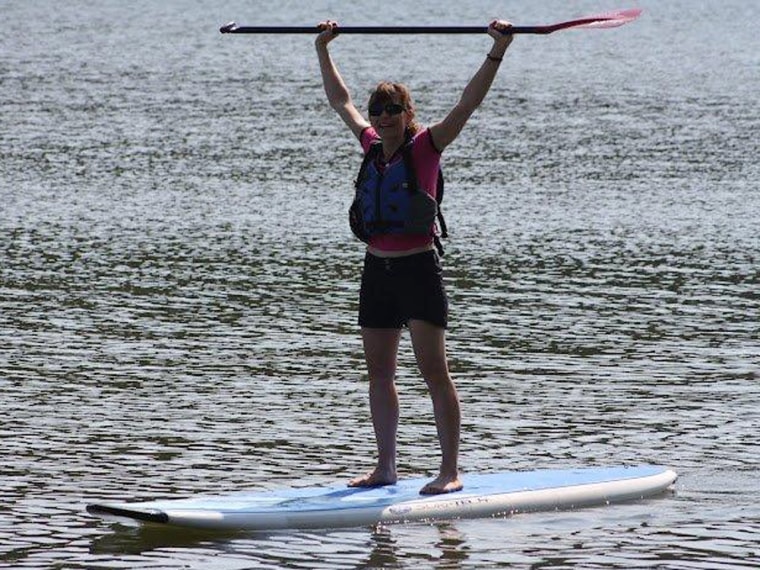 Barbara Teusink of Chapin, S.C., celebrates her first try paddleboarding at a three-day Women's Retreat at Hickory Knob state park sponsored by the South Carolina Wildlife Federation.