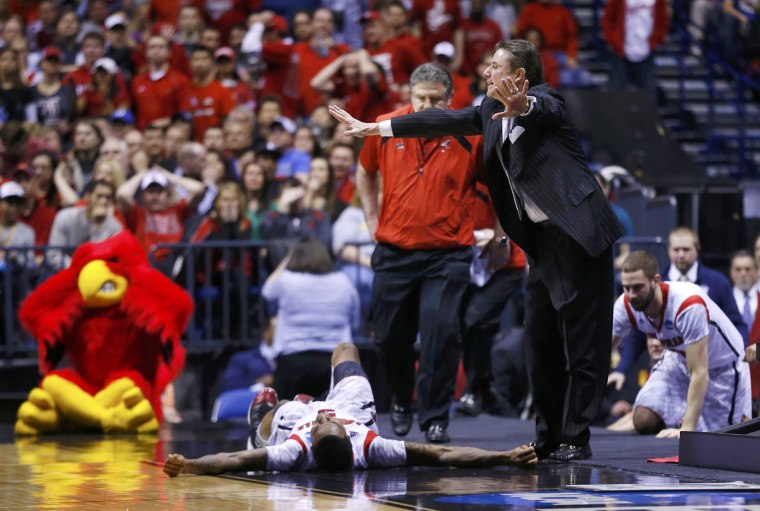 Louisville Cardinals head coach Rick Pitino calls to the referees to stop the game as Cardinals guard Kevin Ware lays on the court with a broken leg in the first half against the Duke Blue Devils during their Midwest Regional NCAA men's basketball game in Indianapolis, Indiana, on March 31, 2013.
