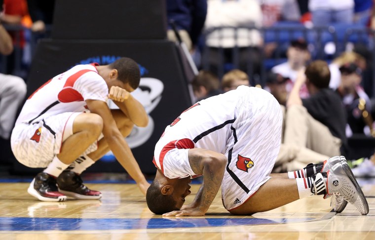Wayne Blackshear #20 and Chane Behanan #21 of the Louisville Cardinals react after Kevin Ware #5 suffered a compound fracture to his leg in the first half against the Duke Blue Devils during the Midwest Regional Final round of the 2013 NCAA Men's Basketball Tournament at Lucas Oil Stadium on March 31, 2013 in Indianapolis, Indiana.