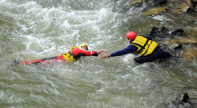 White water rescue attempt takes firefighter for wet ride