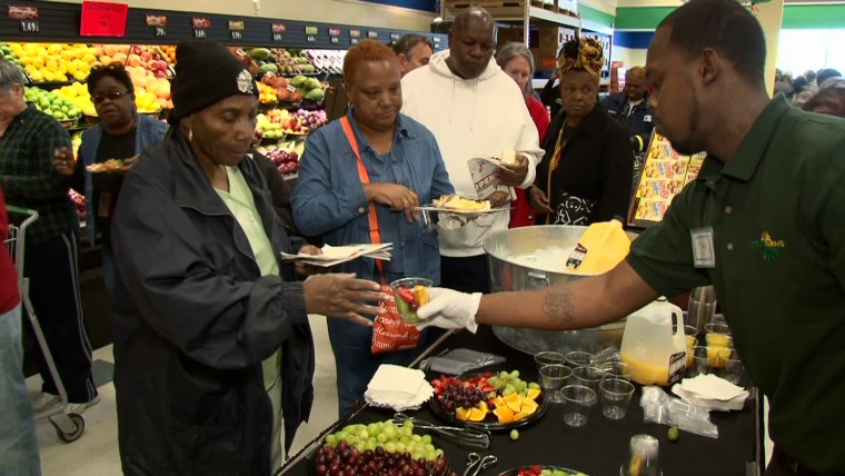 A Sterling Farms employee gives away fresh fruit samples. Food education is an important part of Wendell Pierce's mission.