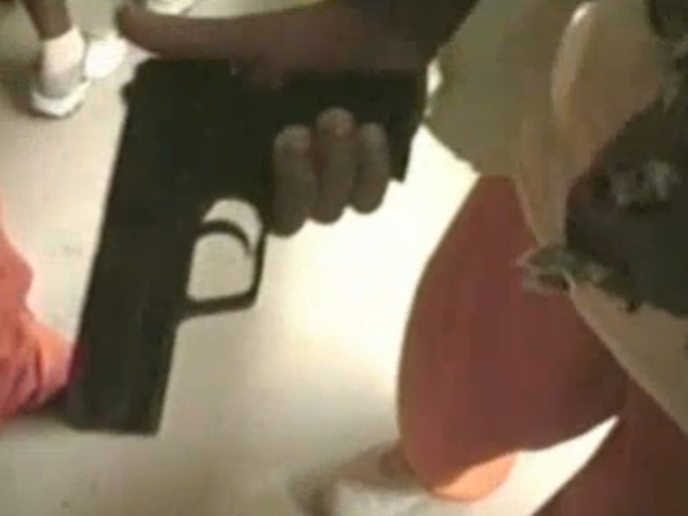 A gun is seen in a still from the video shown in court in New Orleans
