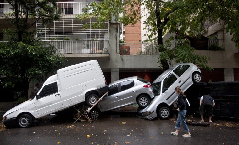 Vehicles tossed by the storm sit along a street in Buenos Aires.