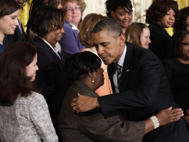 President Barack Obama hugs a gun control activist after delivering remarks on common-sense measures to protect children from gun violence at the White House, March 28, 2013.