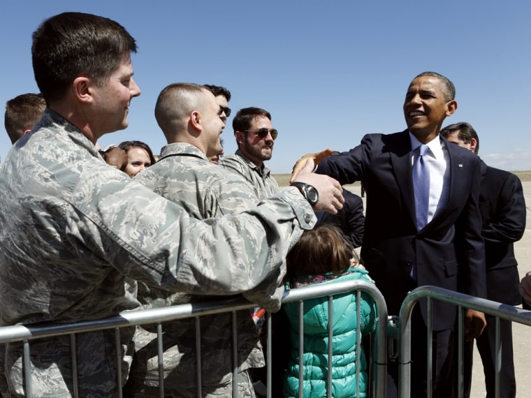 President Barack Obama greets military personnel upon his arrival at Buckely Air Base in Denver, Colorado April 3, 2013.