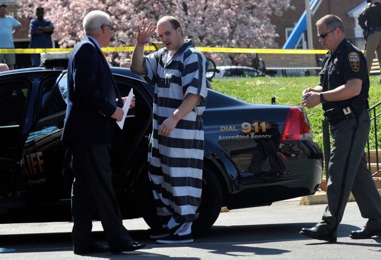 Michael Wayne Hash is escorted to a police car in Culpeper, Va. on March 14, 2012. A Culpeper County Circuit Judge ordered Hash's release after his life sentence for killing an elderly woman was tossed out by a federal judge. That judge overturned Hash's 2001 murder conviction, citing prosecutorial and police misconduct and an inadequate defense.