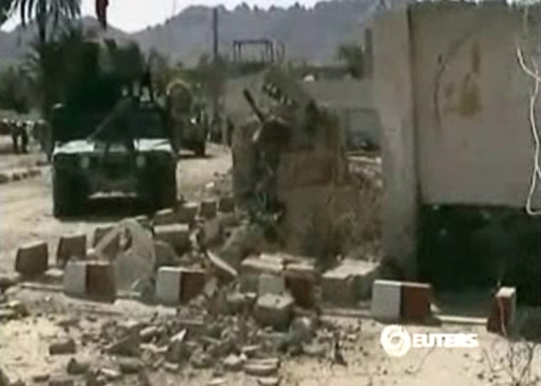 Still image from April 3, 2013 video footage shows damage at the site of an attack by Taliban suicide bombers at a courtroom in Farah province in western Afghanistan.