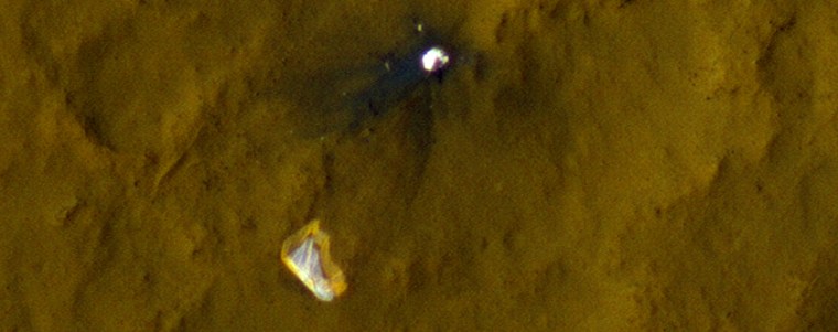 A color picture from the HiRISE camera on NASA's Mars Reconnaissance Orbiter shows the Curiosity rover's parachute and backshell spread out on the Martian surface.