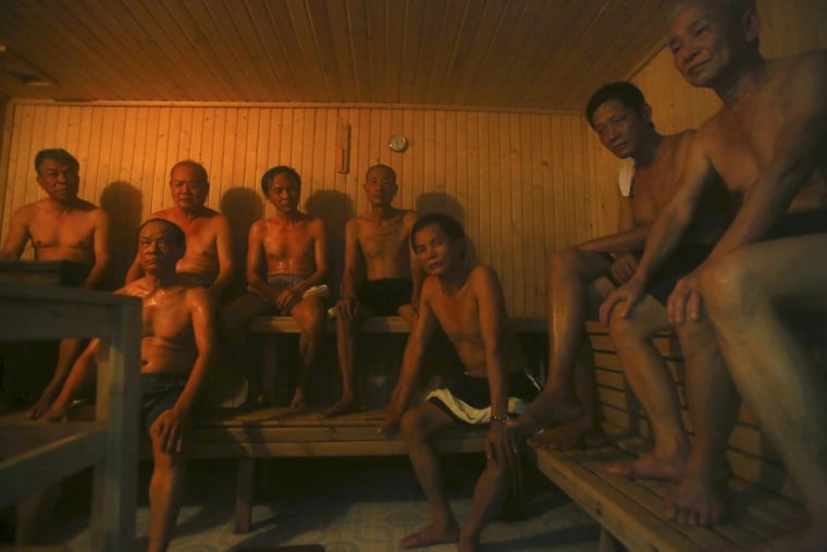Patients sit in a sauna room at the Scientology Health Center of the Vietnam Association of Agent Orange Victims in Thai Binh, Vietnam. The center runs a 25-day health program which, as well as massive consumption of vitamins, includes four-hour sauna sessions and a morning run.