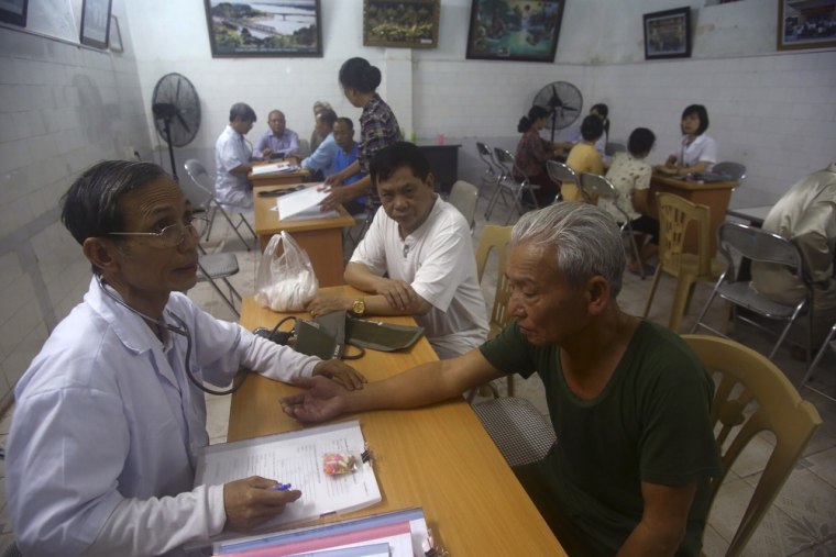 Patients get their pulse and blood pressure checked by doctors at the center. While there is no medical evidence that the treatment is effective, Vietnamese authorities are supporting it as a way of relieving some of the suffering of the between 2 and 4 million people suffering from illnesses linked to exposure to Agent Orange during the war.